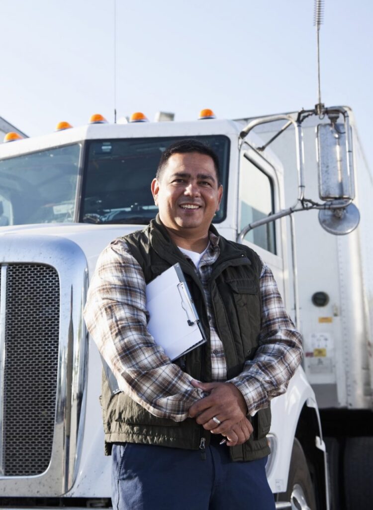 Man in a vest posing in front of a white truck